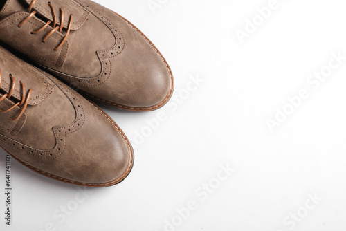 Stylish leather brogue shoes on a white background. Men's footwear. Top view