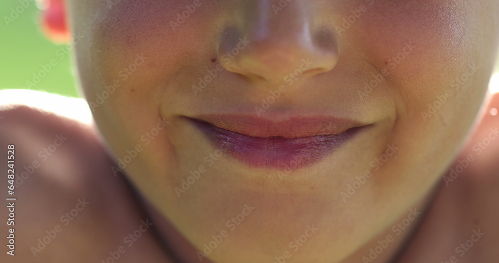 Fototapeta premium Close-up of Child lips smiling, extreme closeup of kid