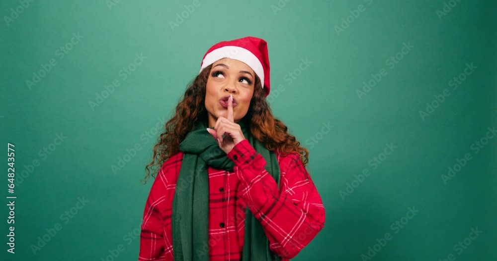Beautiful multi-ethnic woman puts finger on lips, keep secret Christmas studio Beautiful multi-ethnic woman puts finger on lips, keep secret Christmas studio