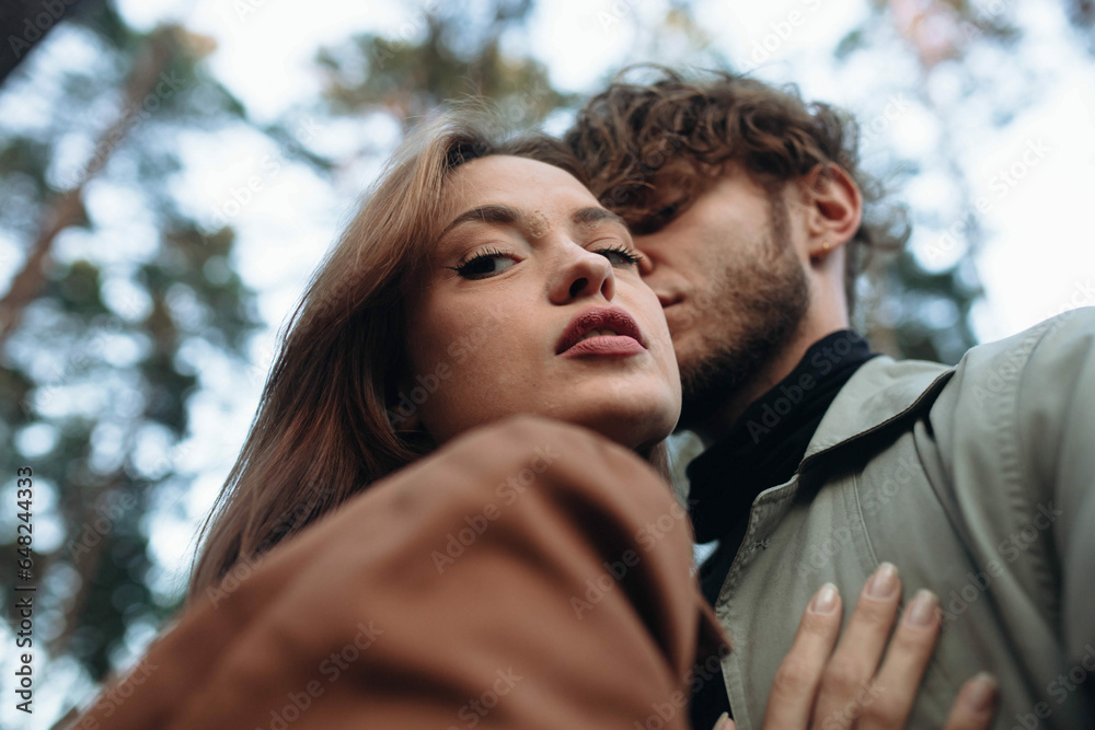 young couple in love kissing in the forest, concept of love relationship and date. Psychological dependence young couple in love kissing in the forest, concept of love relationship and date. Psychological dependence