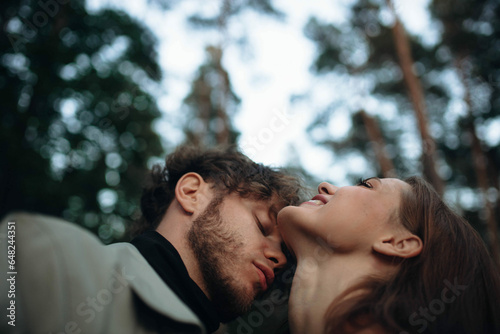 young couple in love kissing in the forest, concept of love relationship and date. Psychological dependence