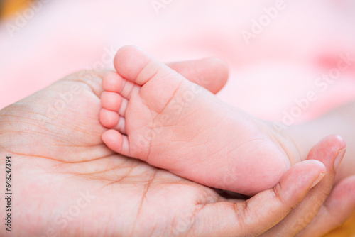 baby feet,Parents hold in the hands and feet of the newborn baby.
