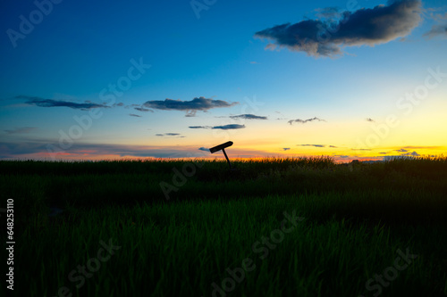 silhouette cross sign on graveyard grass land in evening sunset sky © jaboo_foto