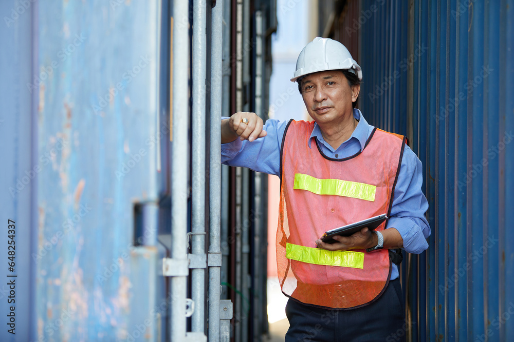 factory worker or engineer holding tablet and working in containers warehouse storage factory worker or engineer holding tablet and working in containers warehouse storage