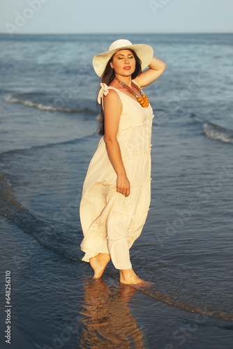 woman in sunhat standing in the water