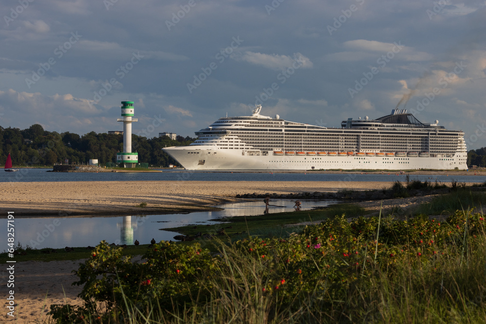 Giant cruise ship passing the Friedrichsort lighthouse at the Falckenstein beach.