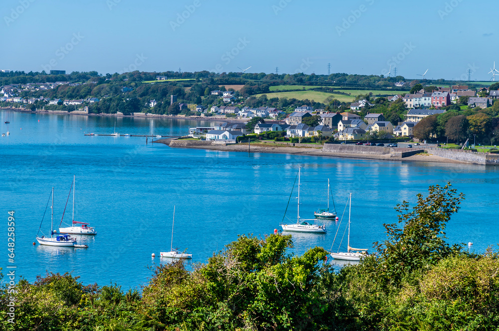 A view past boats moored in the river estuary at Pembroke Dock, Wales in summertime