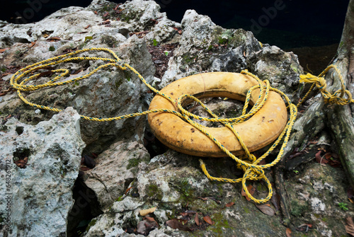 Yellow Safety Ring On The Rocks; Tulum, Mexico photo