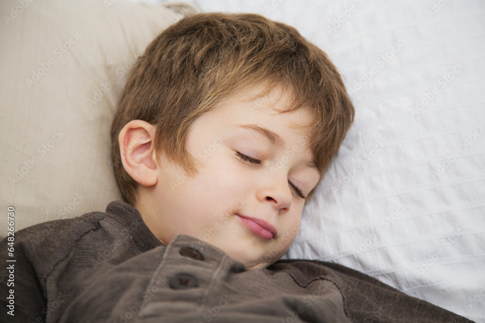 Young Boy Pretending To Be Asleep In Bed; Langley, British Columbia, Canada Young Boy Pretending To Be Asleep In Bed; Langley, British Columbia, Canada