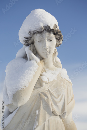 Statue Of A Woman Covered In Snow In Burnsland Cemetery; Calgary, Alberta, Canada photo