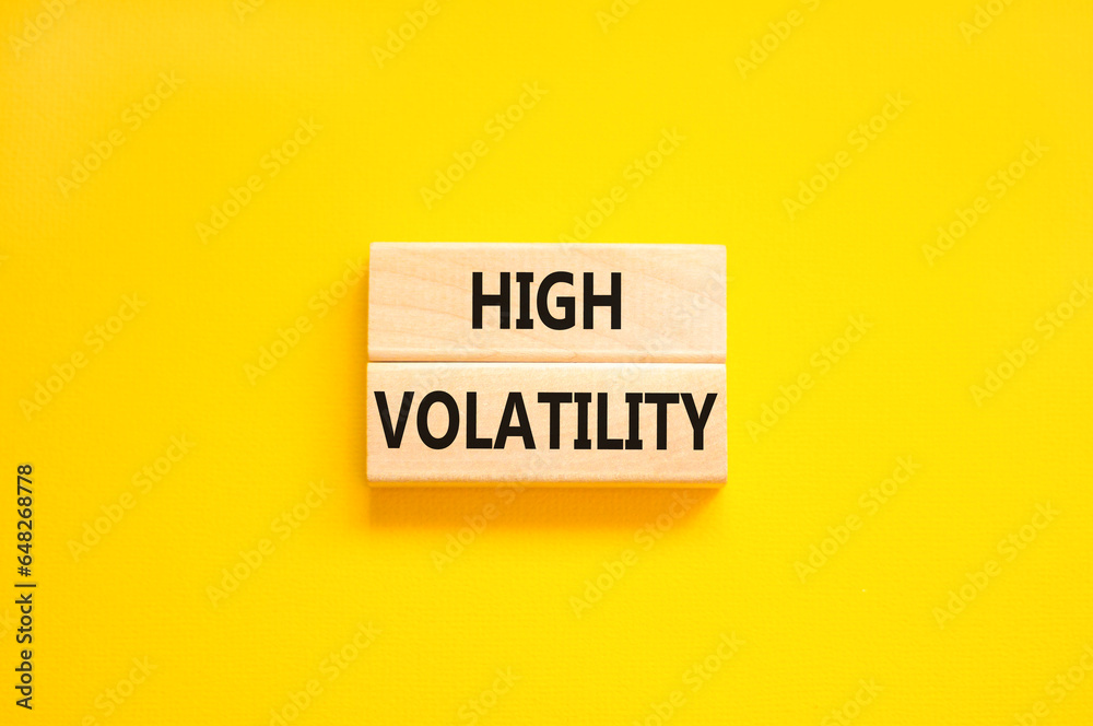 High volatility symbol. Concept words High volatility on beautiful wooden blocks. Beautiful yellow table yellow background. Business high volatility concept. Copy space. High volatility symbol. Concept words High volatility on beautiful wooden blocks. Beautiful yellow table yellow background. Business high volatility concept. Copy space.