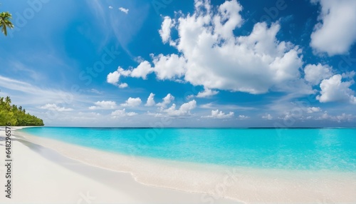 Sandy beach on sunny day with white sand and rolling calm wave of turquoise ocean  white clouds in blue sky background