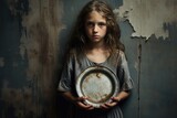 a poor girl holding a empty plate. child hunger concept. poverty and hunger concept. beggar, begging.