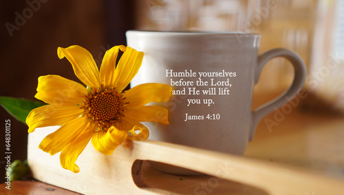Yellow flower with a cup of coffee or tea and bible verse text message on it - Humble yourselves before the Lord, and He will lift you up. James 4 : 10. Christianity concept. photo