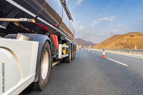 Bilde på lerret Broken down tanker truck on the highway with cones placed by the highway service to cut off the busy lane