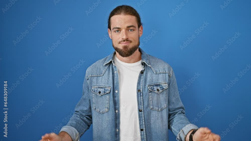 Young hispanic man standing clueless over isolated blue background Young hispanic man standing clueless over isolated blue background
