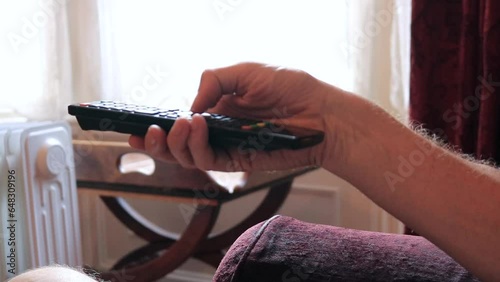 Man Picks Up TV Remote Controller Presses Button Living Room