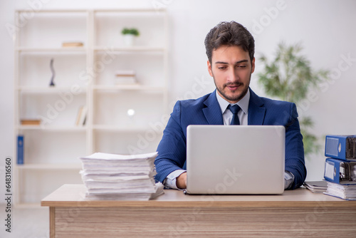 Young male employee working in the office