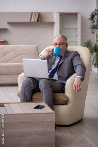 Old male boss working from home during pandemic © Elnur