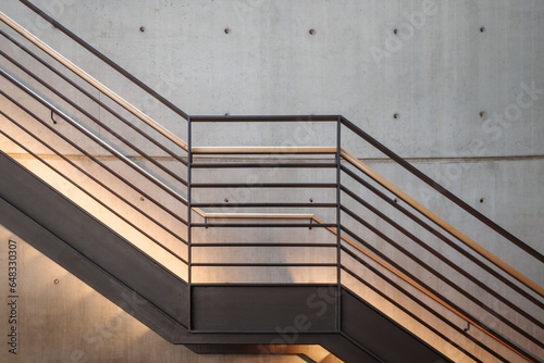 Interior front elevation view at the black steel staircase and background of modern loft concrete wall. photo