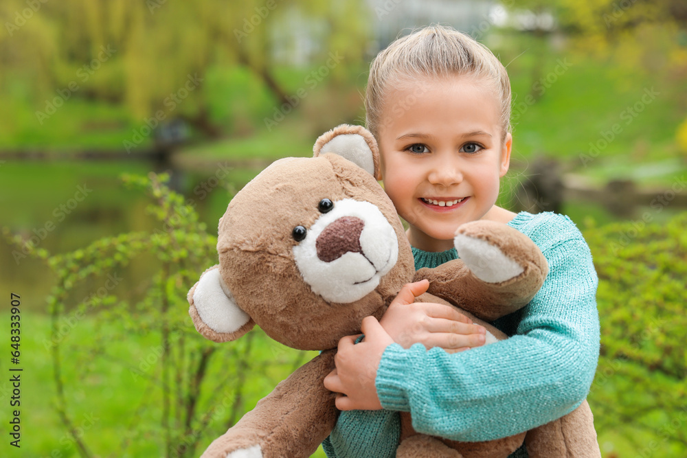 Cute little girl with teddy bear outdoors Cute little girl with teddy bear outdoors