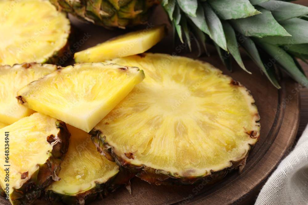 Pieces of tasty ripe pineapple on wooden board, closeup Pieces of tasty ripe pineapple on wooden board, closeup