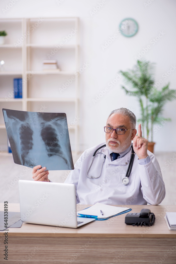 Old male doctor radiologist working in the clinic Old male doctor radiologist working in the clinic