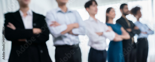 Panorama blurred group of businesspeople stand in line with cross arm gesture in modern corporate. Multiracial officer worker team bond and succeed together. Concord