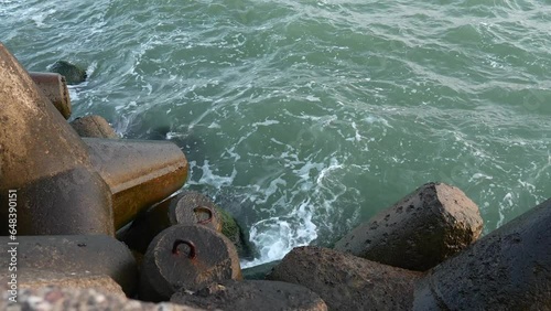 Baltic sea's Embrace at Ventspils Breakwater pier: A Rocky Serenade in Sunset
