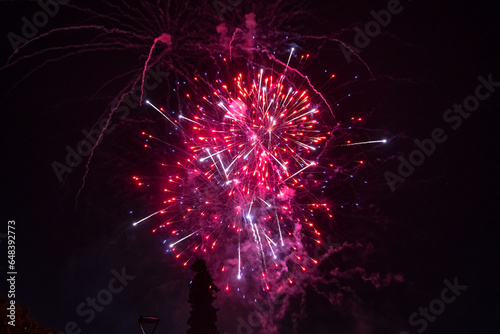 Holiday fireworks explode in the night sky. 4th of July celebration. Selective focus. 