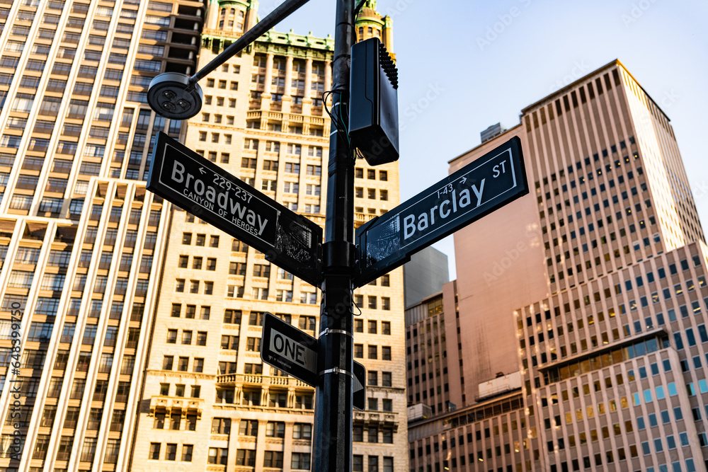 New York City, USA - May 12, 2023: street name sign with lamp at Manhattan Broadway and Barclay street