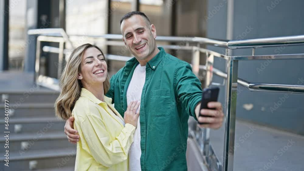 Man and woman couple hugging each other make selfie by smartphone at street Man and woman couple hugging each other make selfie by smartphone at street