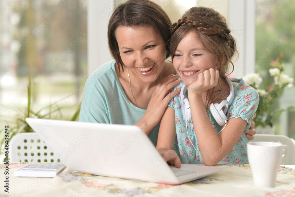 Mother and daughter looking at laptop computer Mother and daughter looking at laptop computer