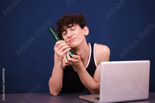 Funny curly guy watches an adult video at home. Blue background. photo