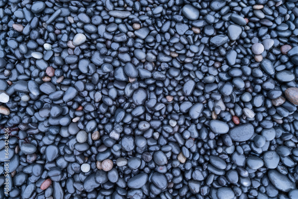 Gray pebbles as a background. Round stones on the beach. Photography for design. Image for background and wallpaper. Textures in nature. Gray pebbles as a background. Round stones on the beach. Photography for design. Image for background and wallpaper. Textures in nature.