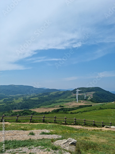 
This is a hillside landscape with a wind turbine.