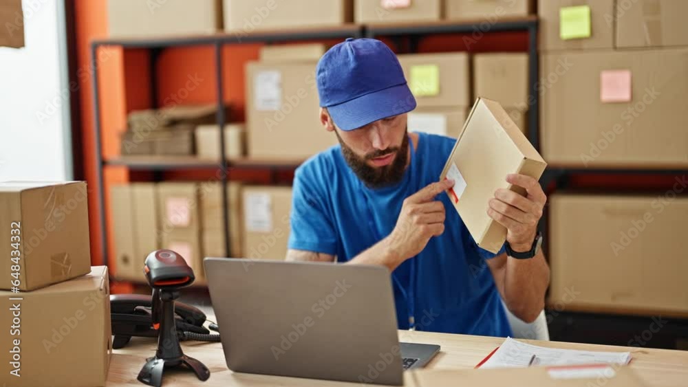 Young hispanic man ecommerce worker having video call holding package at office Young hispanic man ecommerce worker having video call holding package at office