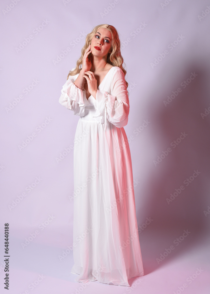Full length portrait of blonde woman wearing white historical bridal gown fantasy costume dress. Standing pose, facing forwards with gestural arms reaching out , isolated on studio background. Full length portrait of blonde woman wearing white historical bridal gown fantasy costume dress. Standing pose, facing forwards with gestural arms reaching out , isolated on studio background.