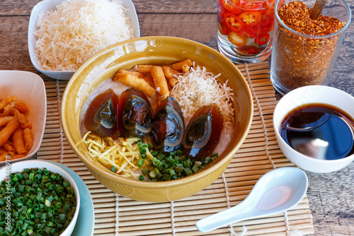 Congee century egg with pork congee with spring onion in a dish - Asian food style