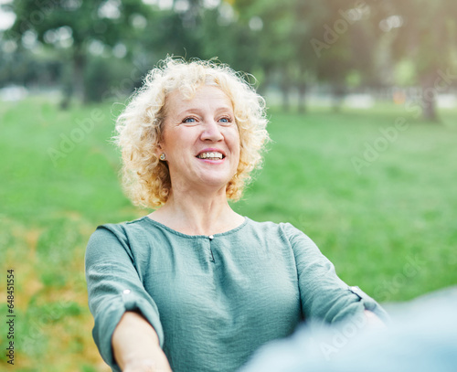 woman mature couple happy together middle aged freedom carefree dancing portrait active vitality man bonding outdoor leisure park fun smiling love