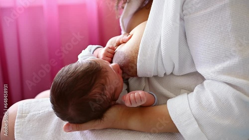 Close-up of a caring loving mother breastfeeding her newborn baby. The importance of breastfeeding for the baby's immune system and prophylaxis of breast cancer. Lactation. Motherhood lifestyle