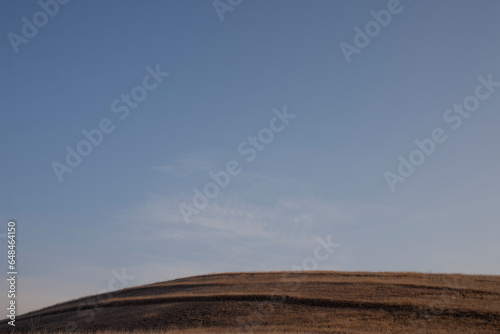 Fototapeta Naklejka Na Ścianę i Meble -  brown grass on the hill at autumn