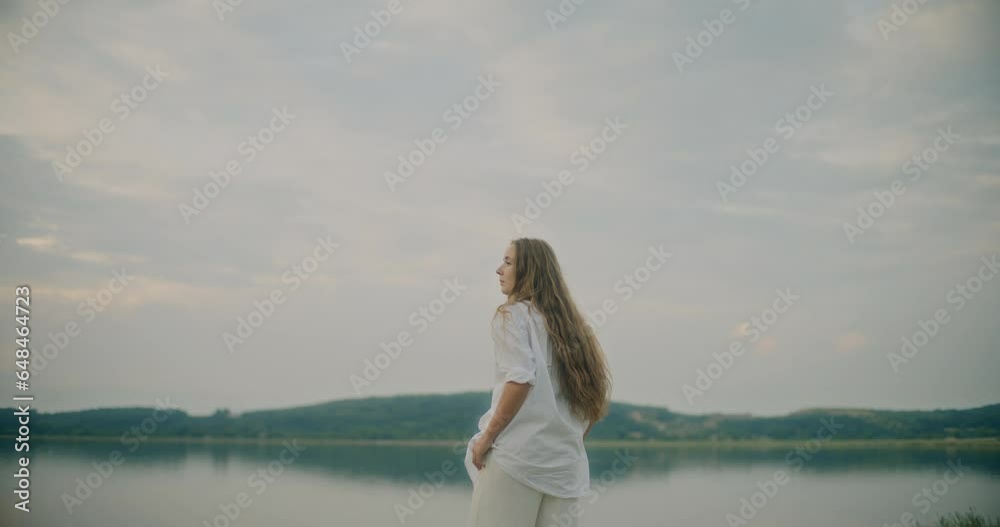 Woman With Blond Hair Exploring Lake Against Sky