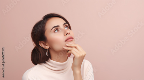 a thoughtful, creative woman gazing into the empty space, her chin resting on her arm, dressed casually against a pastel background.