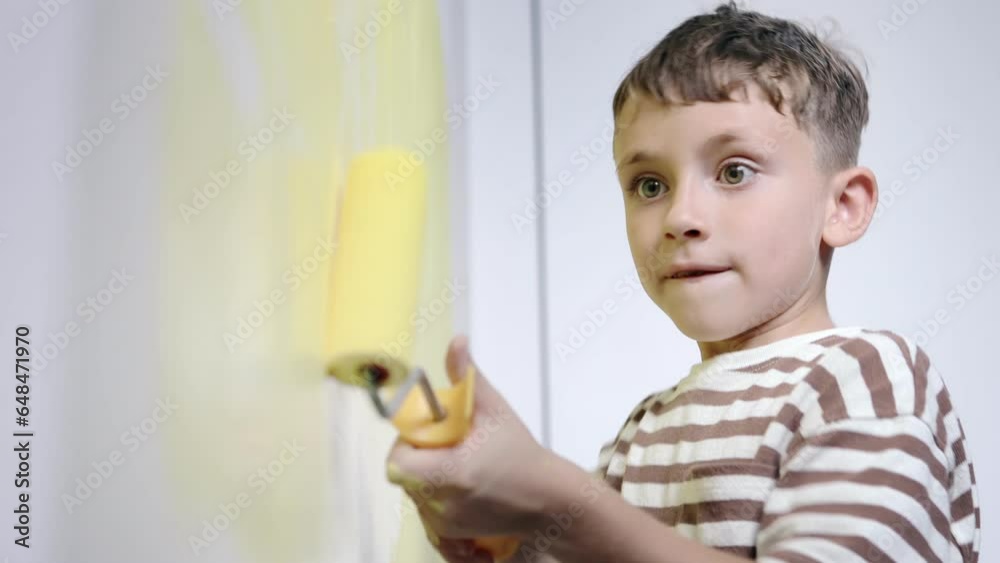 Boy painting wall for yellow paint during home renovation. Boy painting wall for yellow paint during home renovation.