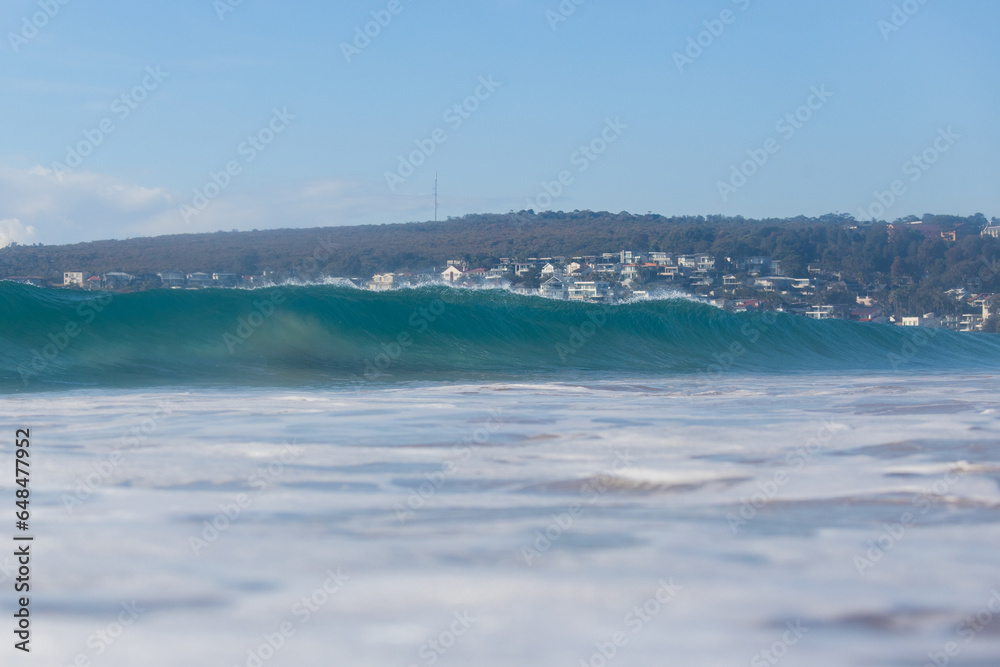 Beautiful blue breaking wave on the beach.
