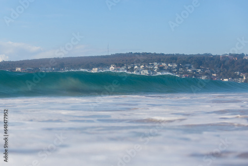 Beautiful blue breaking wave on the beach.
