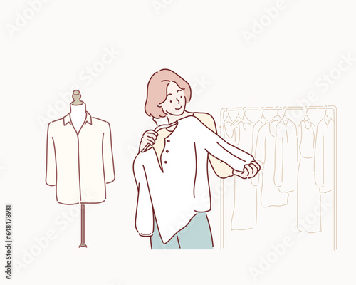 Smiling woman Choose and try on clothe white color in the Tailor shop. Hand drawn style vector design illustrations.