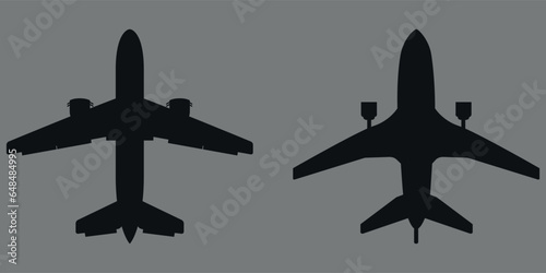 A set of airplane silhouettes. 2 pieces. Black silhouette. Vector on gray background.
