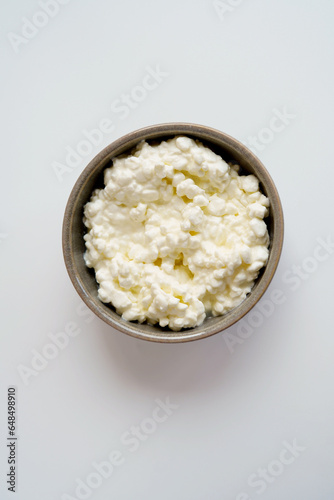 Top view of cottage cheese or queijo fresco in bowl on the white background © BooFamily